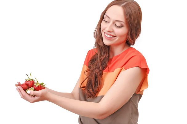 Red-haired woman holding strawberries - Zdjęcie, obraz