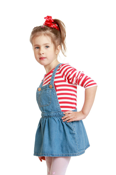 Little Caucasian blond girl in a short denim dress  - Фото, зображення
