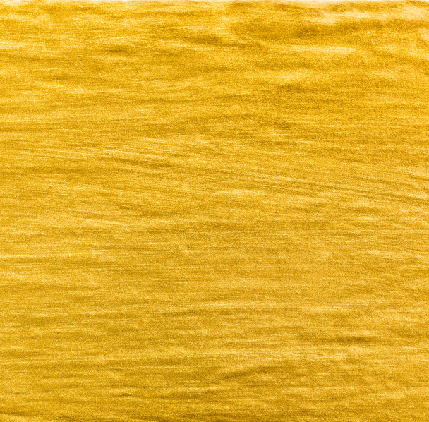 achtergrond en de textuur van gouden kleur verf op de muur - Foto, afbeelding
