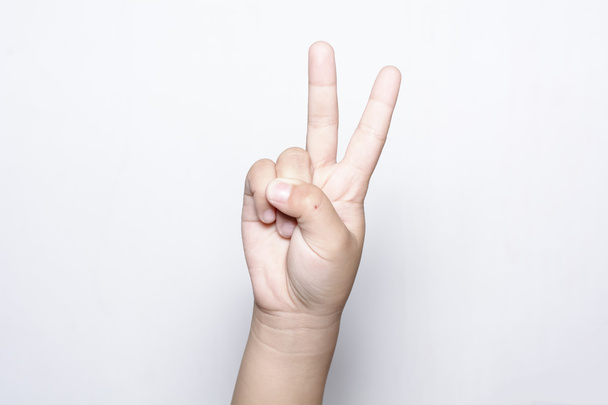 Lány két ujját fel a kezét - Fotó, kép