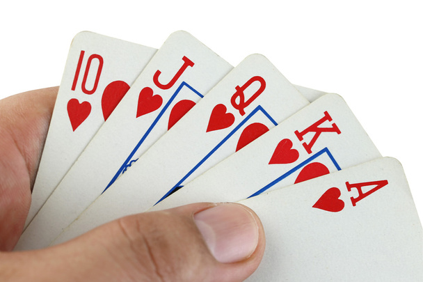 Королевский флеш игральные карты в руке
. - Фото, изображение