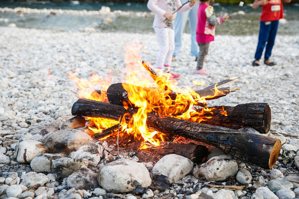 Family enjoying time by the river and self-made campfire  - Photo, image