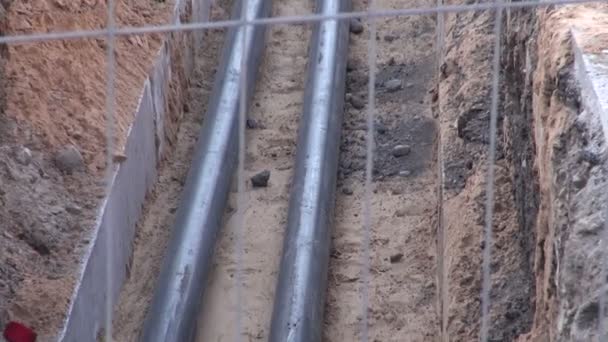 modern heating plastic pipes in trench and road signs on street - Footage, Video