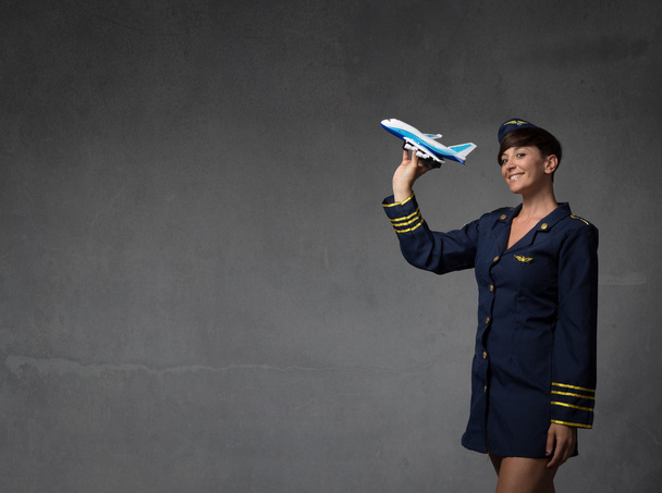 hostess plaing with a toy plane - Foto, afbeelding