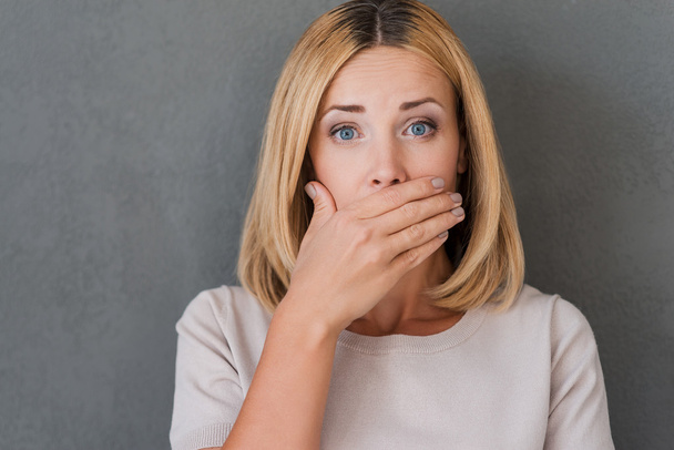 Surprised mature woman covering mouth - Photo, image