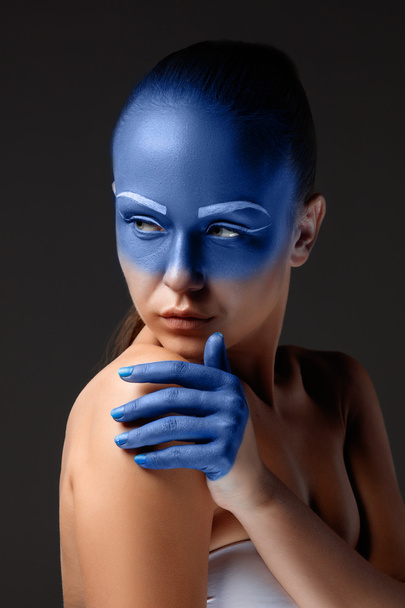 Portrait of a woman who is posing covered with blue paint - Fotoğraf, Görsel