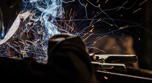 Welder in action with bright sparks. - Photo, Image