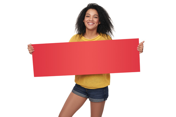 Happy african american girl showing blank banner - Fotó, kép