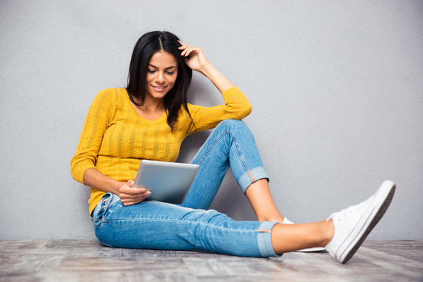 Girl sitting on the floor with tablet computer  - Фото, зображення