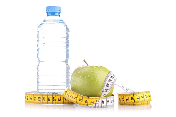 Water bottle and green apple with meter - Foto, immagini