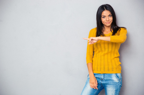 Woman in sweater showing finger away - Photo, Image