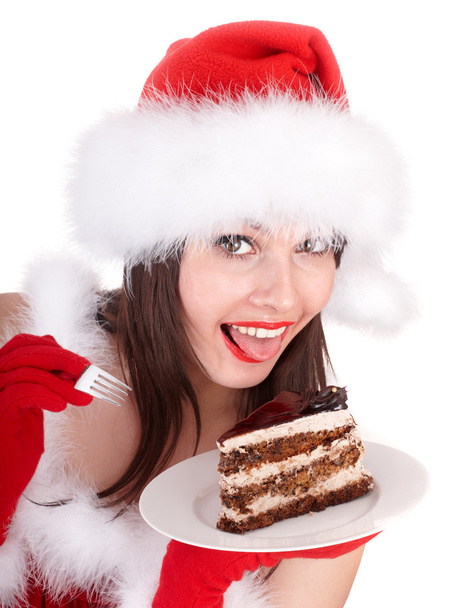 Χριστούγεννα κορίτσι σε κόκκινο καπέλο santa και κέικ στο πιάτο. - Φωτογραφία, εικόνα