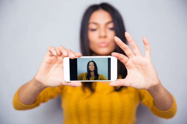 Woman making selfie photo on smartphone  - 写真・画像