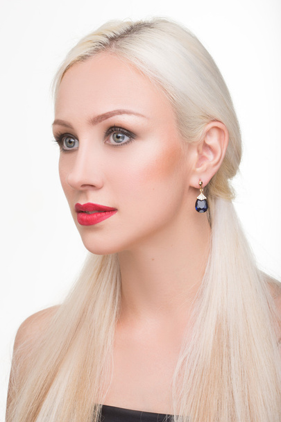 beautiful girl with long white hair and earrings. fashionable photo. portrait - Fotó, kép
