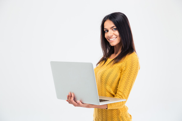 Woman standing and using laptop - Foto, imagen