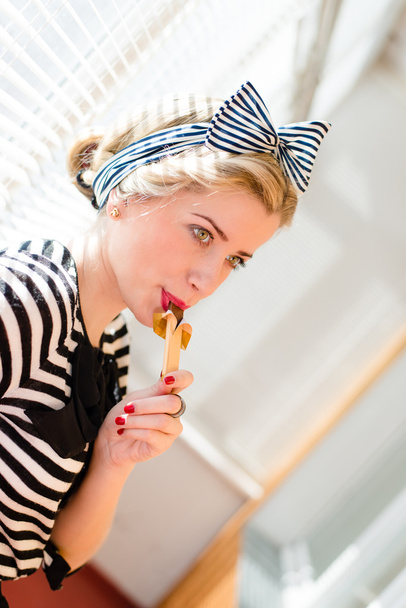 Beautiful blond young woman having fun eating chocolate - Фото, зображення