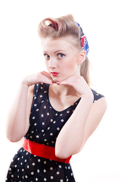 Pinup young woman in polka dot dress and victory rolls - Foto, immagini
