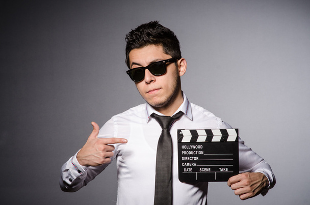 Young man in cool sunglasses holding chalkboard isolated on gray - Photo, Image