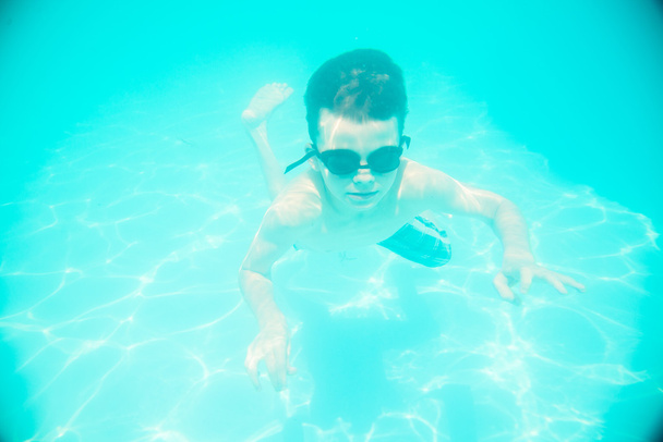 A little boy swimming underwater in the pool - Photo, Image