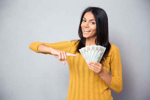 Woman pointing finger on dollar bills - Фото, зображення