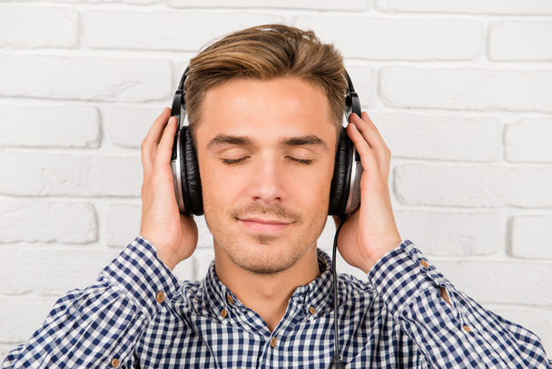 stylish man listening to music on headphones - Fotoğraf, Görsel