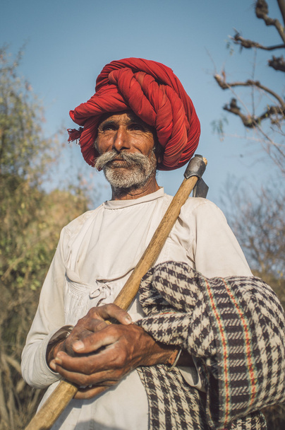 Rabari tribesman holds traditional axe - Valokuva, kuva