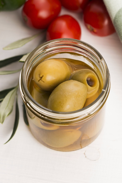 pickled olives and olive tree branch - Фото, зображення