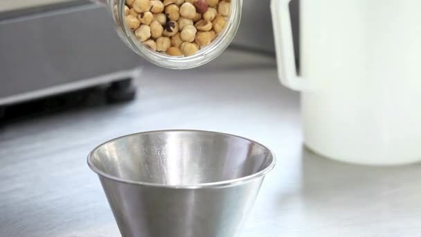 shelled hazelnuts poured from the jar in a bowl - Footage, Video