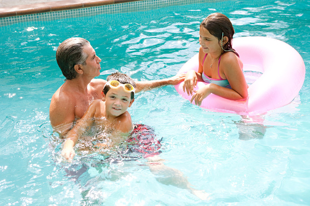 сім'я плаває разом у басейні
 - Фото, зображення