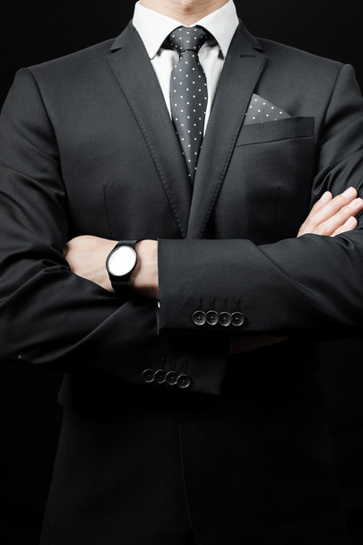 man in suit on a black background - 写真・画像