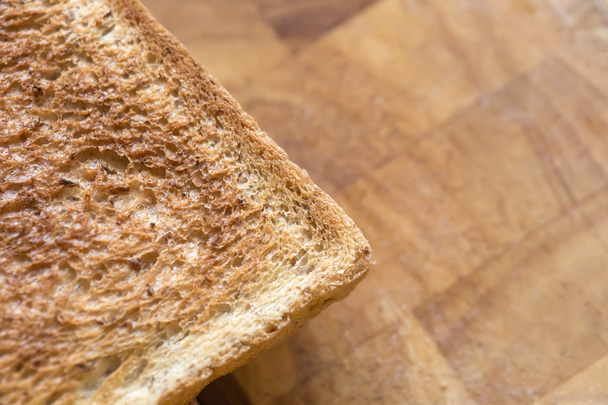 Toast bread over wooden background on right side,closeup - Photo, Image