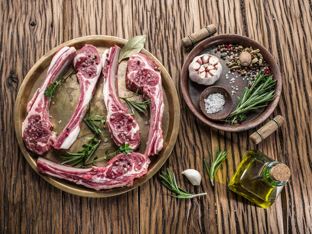 Raw lamb chops with garlic and herbs. - Fotó, kép