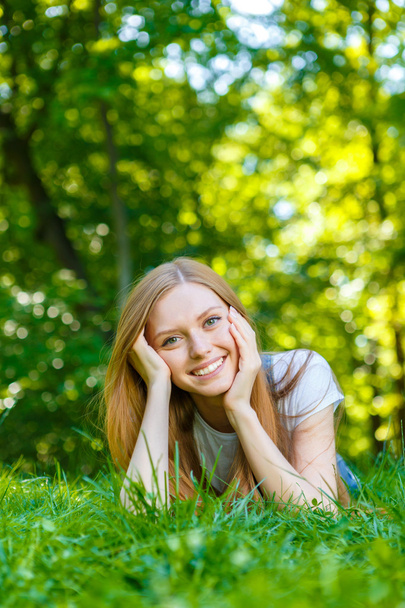 Beautiful smiling red-haired young woman - 写真・画像