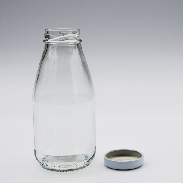Empty colorless glass bottle on White Background - Foto, afbeelding