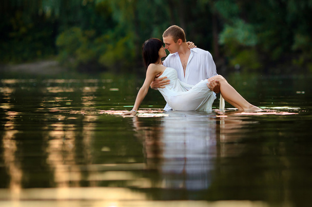 A beautiful young couple in the water - Photo, image