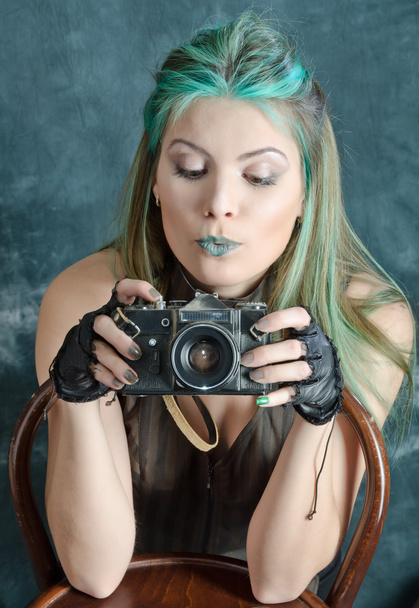 Steampunk-styled girl experiments with old fashion camera - Photo, Image