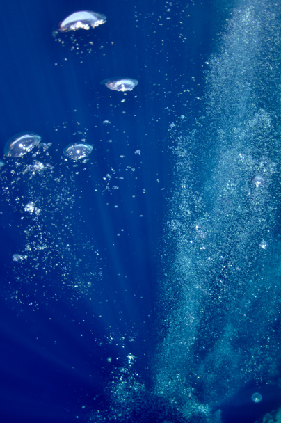 Raising underwater bubbles in the blue sea - Photo, Image