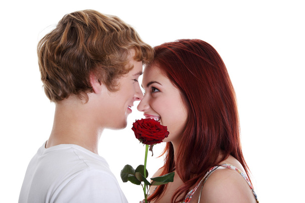 Young couple holding red rose. - Foto, imagen