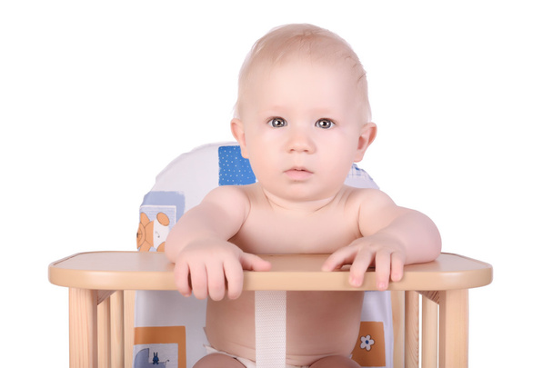 Adorable baby in high chair isolated - Foto, Bild