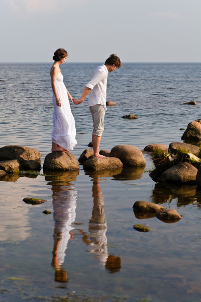 Young romantic pair walks at water - Photo, Image