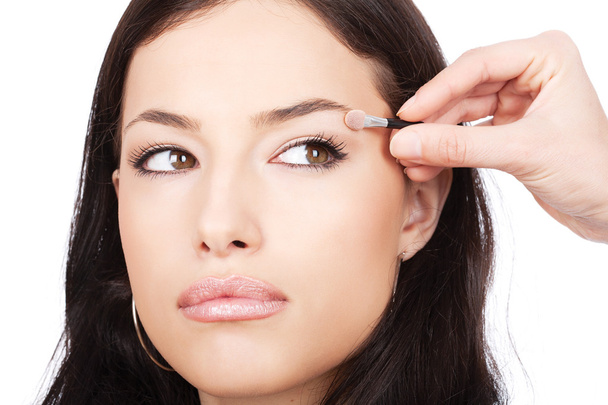 Model receives eyeshadow from make-up artist - Foto, Bild