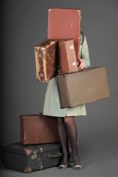 Young woman and a lot of old suitcases - Fotó, kép