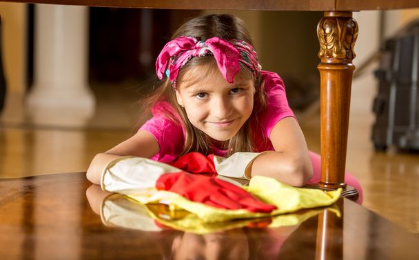 chica sonriente en guantes de goma mesa de limpieza por trapo
 - Foto, imagen