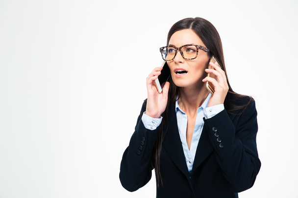Businesswoman talking on two phones - Foto, Bild