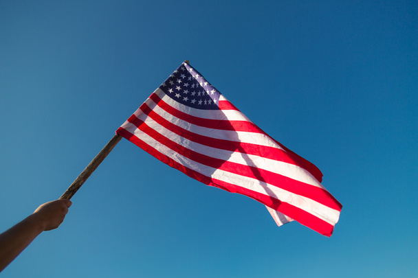 American flag with stars and stripes hold with hand - Fotografie, Obrázek