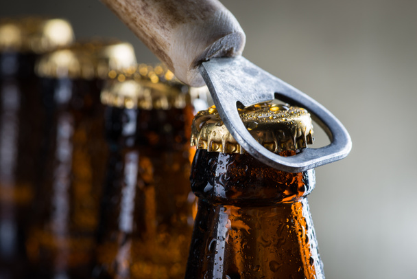 Botellas de cerveza fría de hielo marrón con abridor viejo
 - Foto, Imagen
