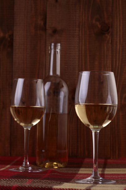 Wine bottle and glasses on plaid - Fotoğraf, Görsel
