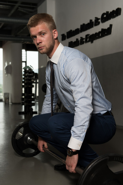 Healthy Young Businessman Doing Exercise For Back - Foto, afbeelding