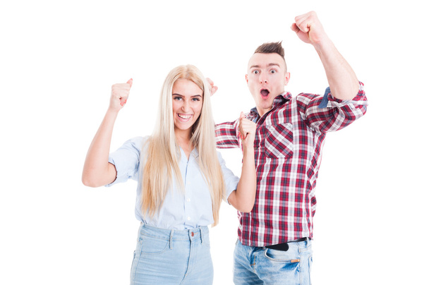 Excited and cheerful couple raising hands up - Photo, Image