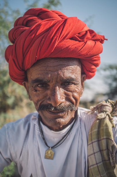 tribesman with red turban posing - 写真・画像